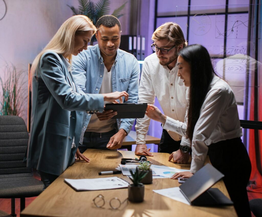 Team of financial experts using tablet during brainstorming